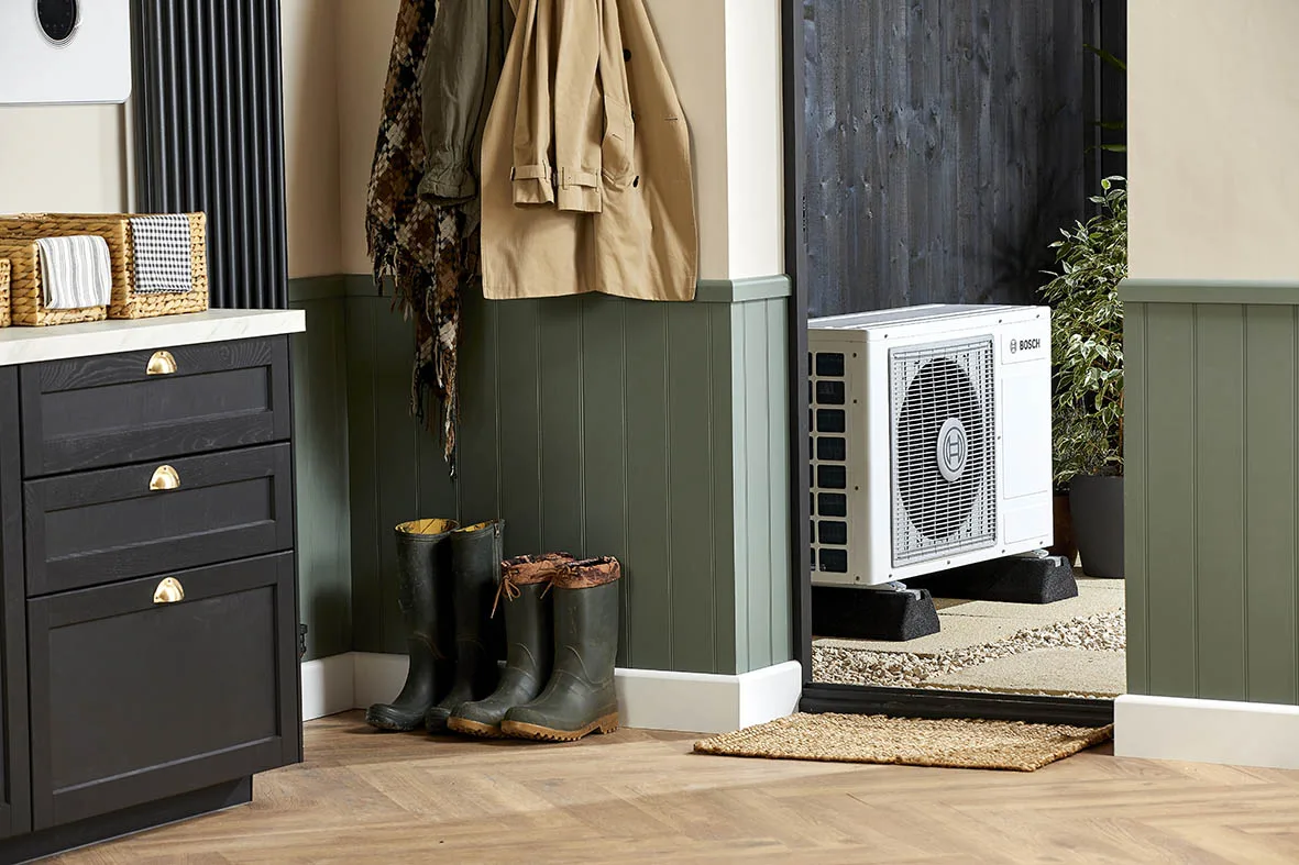 Engineer servicing heat pump